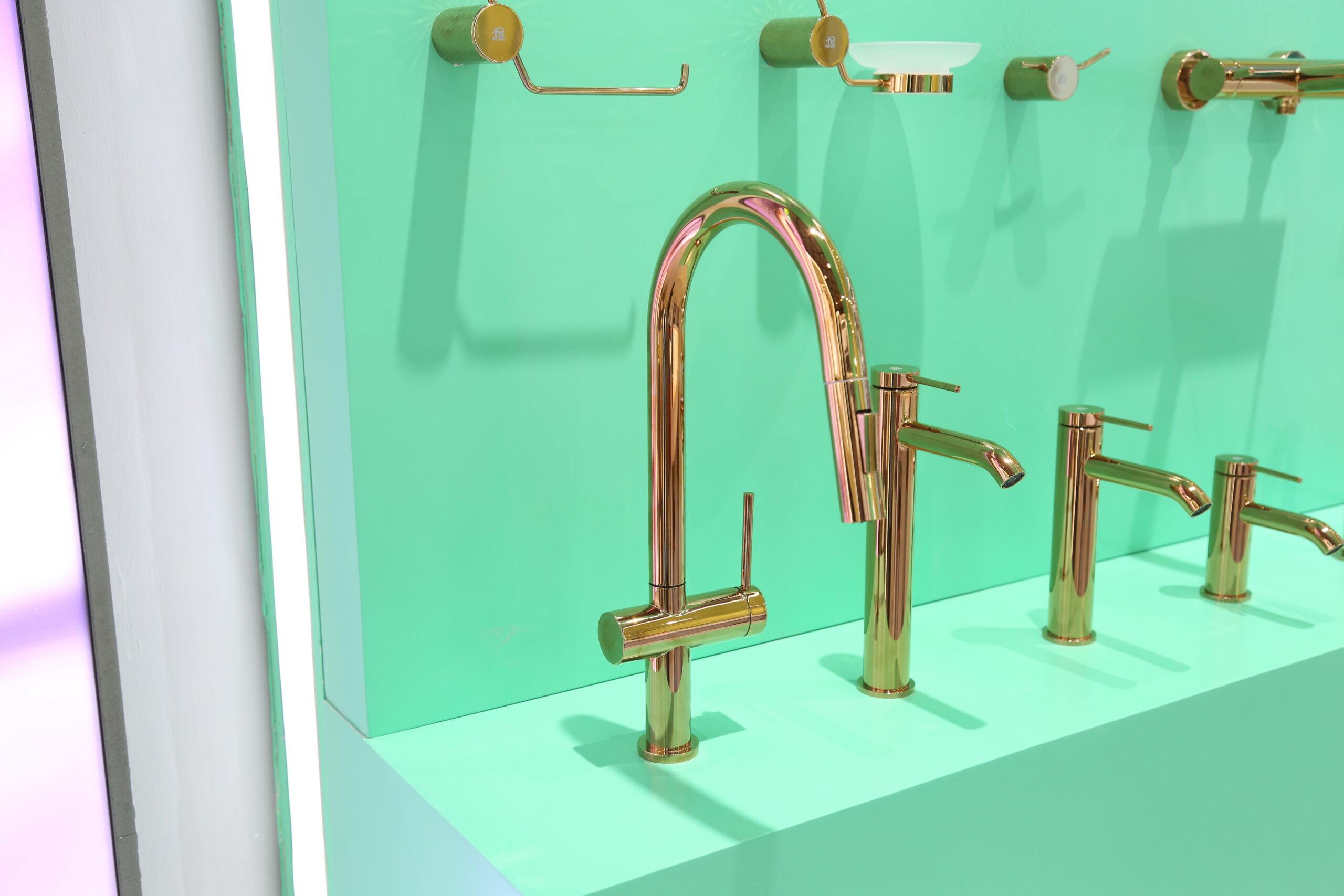 New Sunny Series brass bathroom suite --display: wall-mounted faucets, towel racks and soap dishes on teal backdrop with 